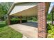 Attached carport with brick columns and ample space for parking, providing convenient covered access to the home at 319 Glenhaven Dr, Charlotte, NC 28214