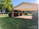 Covered carport with brick pillars, offering sheltered parking and easy access to the home's outdoor space at 319 Glenhaven Dr, Charlotte, NC 28214