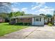 Inviting home with a brick exterior and a convenient carport, set amidst a well-manicured lawn and mature trees at 319 Glenhaven Dr, Charlotte, NC 28214