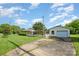 Well-maintained home with a detached garage and a white picket fence, showcasing its curb appeal and outdoor amenities at 319 Glenhaven Dr, Charlotte, NC 28214
