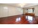 Bright living room with hardwood floors, natural light, a decorative chandelier, and a large bay window at 319 Glenhaven Dr, Charlotte, NC 28214