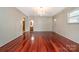 Spacious living room with hardwood floors and an arched doorway, offering a seamless flow and inviting atmosphere at 319 Glenhaven Dr, Charlotte, NC 28214