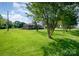 Expansive grassy yard with mature trees, showcasing the generous outdoor space of this well-maintained property at 319 Glenhaven Dr, Charlotte, NC 28214
