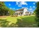 Spacious backyard with lush lawn, stone patio, and outdoor seating, perfect for entertaining and relaxation at 3918 Halcyon Dr, Huntersville, NC 28078