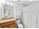 Bathroom featuring a sink, a toilet, a cabinet, and a shower with white curtains at 3918 Halcyon Dr, Huntersville, NC 28078