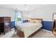 Cozy bedroom featuring a ceiling fan, window with curtains, and a wooden dresser at 3918 Halcyon Dr, Huntersville, NC 28078