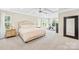 Spacious bedroom with tray ceiling, large windows, and a personal exercise bike at 3918 Halcyon Dr, Huntersville, NC 28078