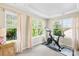 Bedroom with lots of natural light featuring an exercise bike and mirrored side table at 3918 Halcyon Dr, Huntersville, NC 28078