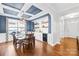 Elegant dining room with coffered ceilings, stylish light fixture, wine refrigerator, and hardwood floors at 3918 Halcyon Dr, Huntersville, NC 28078
