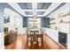 Elegant dining room featuring hardwood floors, coffered ceilings, built-in cabinets, mini-fridge and large windows at 3918 Halcyon Dr, Huntersville, NC 28078