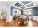 Dining room showcasing hardwood floors, coffered ceilings, fireplace, and seamless flow into the living room at 3918 Halcyon Dr, Huntersville, NC 28078