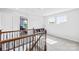 Upstairs hallway with neutral carpet, a view into a bedroom, and natural light at 3918 Halcyon Dr, Huntersville, NC 28078