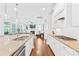 Modern kitchen with white cabinets and granite countertops flows into the living space at 3918 Halcyon Dr, Huntersville, NC 28078