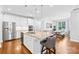 Spacious open-concept kitchen featuring an island with seating and stainless steel appliances at 3918 Halcyon Dr, Huntersville, NC 28078