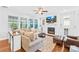 Cozy living room featuring a fireplace, built-in cabinets, plush seating, and a large window at 3918 Halcyon Dr, Huntersville, NC 28078