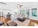 Open living area with large sectional, centered around windows for natural light at 3918 Halcyon Dr, Huntersville, NC 28078