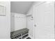 Clean mudroom area with a bench, storage baskets, hooks, and a door to the outside at 3918 Halcyon Dr, Huntersville, NC 28078