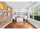 Bright office space featuring wood floors, built-in shelves, a large window, and modern decor at 3918 Halcyon Dr, Huntersville, NC 28078