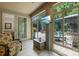 Bright sunroom featuring a TV, glass windows, outdoor patio and comfortable seating at 3918 Halcyon Dr, Huntersville, NC 28078