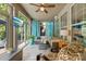 Cozy sunroom featuring a TV, large windows with outdoor views, and comfortable seating at 3918 Halcyon Dr, Huntersville, NC 28078