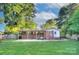 Spacious backyard featuring a covered patio, brick exterior and grassy lawn at 3951 Whitehall Dr, Charlotte, NC 28208