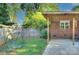 Large green backyard featuring a covered patio, mature trees and landscaping at 3951 Whitehall Dr, Charlotte, NC 28208