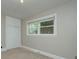 A bright bedroom featuring neutral walls, large windows, and carpet at 3951 Whitehall Dr, Charlotte, NC 28208