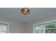 Bedroom shows a modern ceiling light fixture and window with natural light at 3951 Whitehall Dr, Charlotte, NC 28208