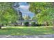 Charming single-story home with mature trees and a well-manicured lawn at 3951 Whitehall Dr, Charlotte, NC 28208