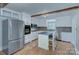 Updated kitchen with custom cabinets, modern appliances, and a breakfast bar at 3951 Whitehall Dr, Charlotte, NC 28208