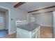 Eat-in kitchen with stone countertops, island, and wood beam details at 3951 Whitehall Dr, Charlotte, NC 28208