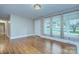 Inviting living room with hardwood floors, large windows, and neutral paint at 3951 Whitehall Dr, Charlotte, NC 28208
