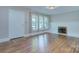 Bright living room featuring refinished hardwood floors and a cozy fireplace at 3951 Whitehall Dr, Charlotte, NC 28208