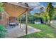 Covered patio area with lighting, outdoor furniture and manicured backyard at 3951 Whitehall Dr, Charlotte, NC 28208
