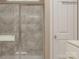 Bathroom featuring a glass-door shower with marble paneling at 4179 Skyboat Cir, Fort Mill, SC 29715