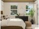 Bright bedroom featuring two windows, a decorative mirror, and stylish furniture at 4179 Skyboat Cir, Fort Mill, SC 29715