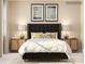 Beautiful primary bedroom features coordinated nightstands, lamps and accent artwork at 4179 Skyboat Cir, Fort Mill, SC 29715