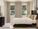 Comfortable primary bedroom features two windows and neutral color palettes at 4179 Skyboat Cir, Fort Mill, SC 29715