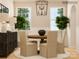 Dining room with round wood table, modern chairs, buffet, and large windows at 4179 Skyboat Cir, Fort Mill, SC 29715