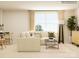 Bright living area with a cozy sectional, large windows, and a functional desk space, ideal for modern living at 4231 Skyboat Cir, Fort Mill, SC 29715