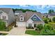 An aerial shot showcasing the well-maintained home, its manicured lawn, and the surrounding neighborhood at 4527 Waylon Ave, Fort Mill, SC 29715