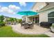 Backyard patio features an outdoor dining area, barbecue grill, and comfortable seating with mature trees at 4527 Waylon Ave, Fort Mill, SC 29715