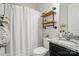 Bright bathroom with granite vanity, wood shelves, and white shower curtain at 4527 Waylon Ave, Fort Mill, SC 29715