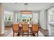 Bright dining room with a modern light fixture, views of the backyard and adjacent living areas at 4527 Waylon Ave, Fort Mill, SC 29715