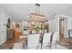 Dining room featuring an open concept to a modern kitchen with white cabinets and stainless steel appliances at 4527 Waylon Ave, Fort Mill, SC 29715
