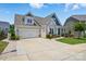 Charming single-Gathering home with an attached garage and beautifully landscaped front yard at 4527 Waylon Ave, Fort Mill, SC 29715