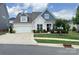 Charming home featuring a manicured lawn, lush landscaping, and a welcoming front entrance at 4527 Waylon Ave, Fort Mill, SC 29715