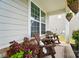 Inviting front porch with cozy seating, plants and view of the yard at 4527 Waylon Ave, Fort Mill, SC 29715