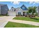 Charming single-Gathering home featuring a manicured lawn and beautiful landscaping with a two-car garage at 4527 Waylon Ave, Fort Mill, SC 29715