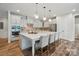 Bright kitchen with white cabinets, a large island with seating, and modern stainless steel appliances at 4527 Waylon Ave, Fort Mill, SC 29715
